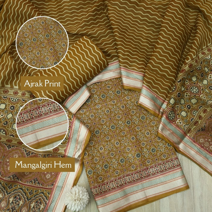 दिपशा Mustard Brown Ajrak Printed Mangalgiri Hem Work Cotton Suit Set