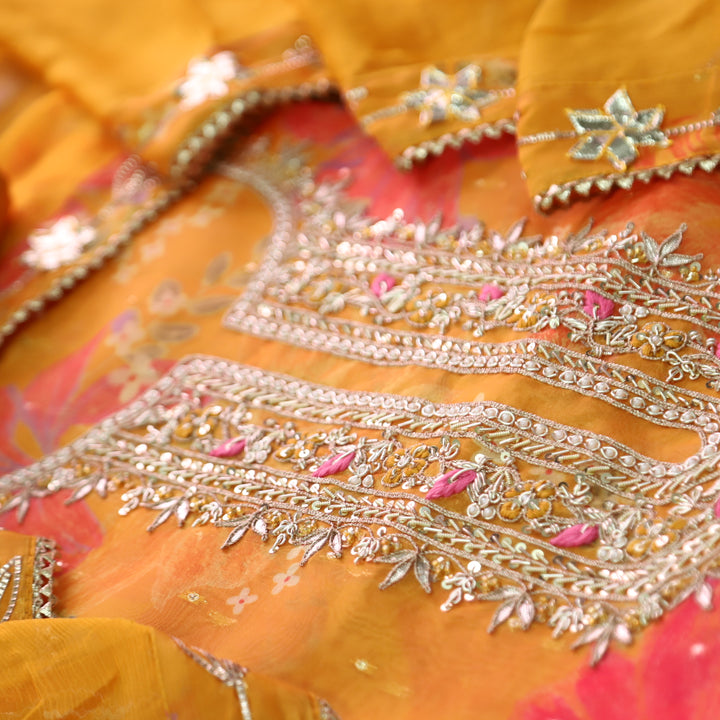 Sakhi Tangerine Yellow with Embellish Neck Work in Floral Printed Organza Suit Set