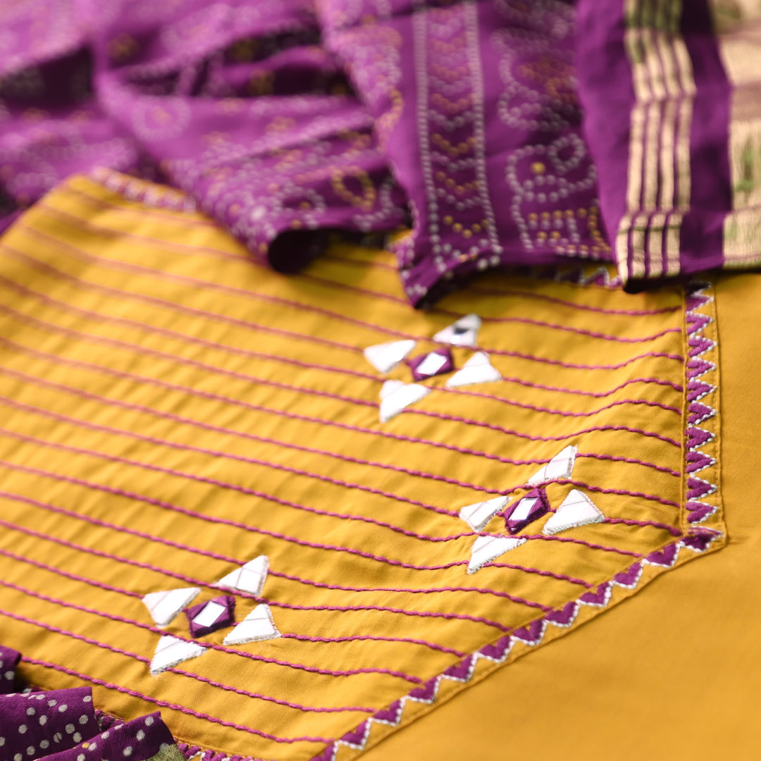 Saheli Turmeric Yellow Thread Embroidered Neck with Mirror Work Roman Silk Set
