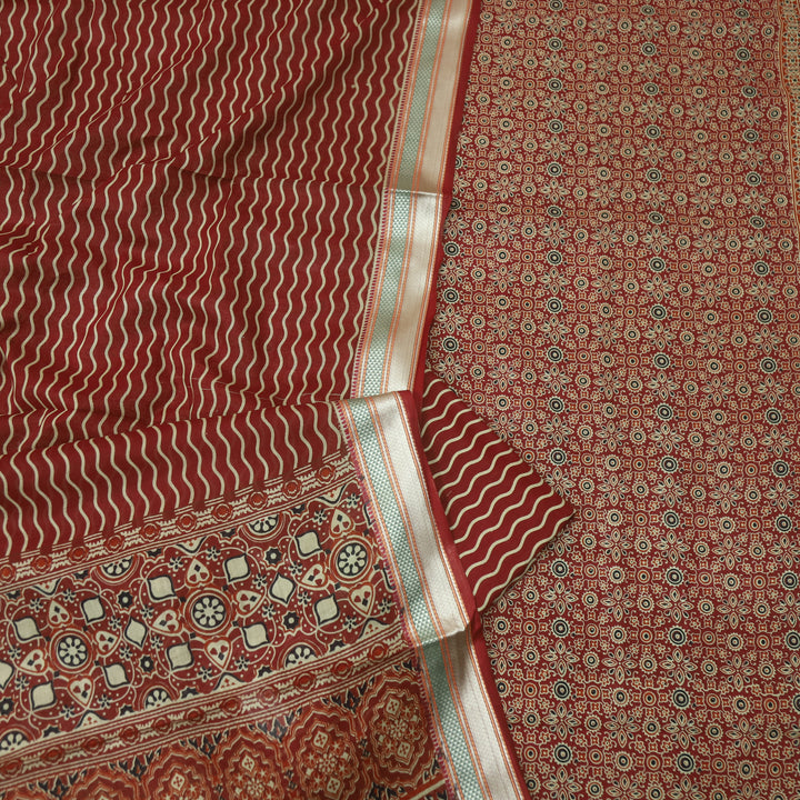 दिपशा Cheery Red Ajrak Printed Mangalgiri Hem Work Cotton Suit Set