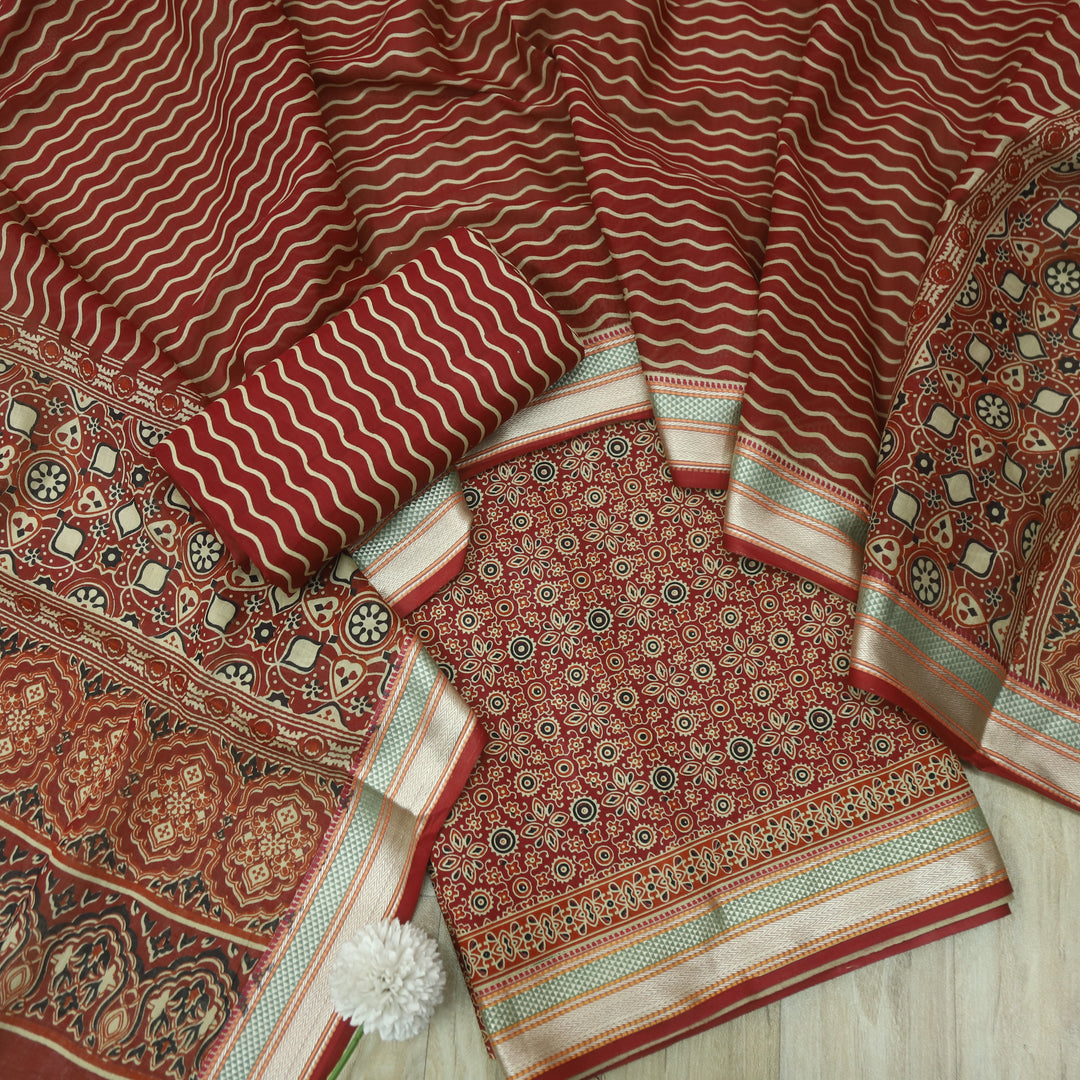 दिपशा Cheery Red Ajrak Printed Mangalgiri Hem Work Cotton Suit Set
