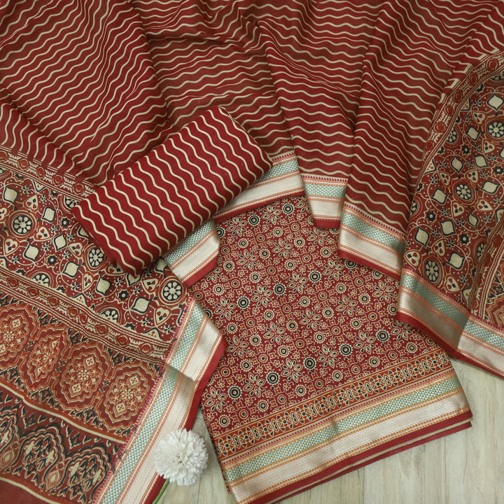 दिपशा Cheery Red Ajrak Printed Mangalgiri Hem Work Cotton Suit Set