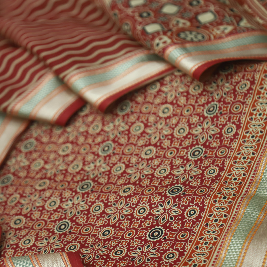 दिपशा Cheery Red Ajrak Printed Mangalgiri Hem Work Cotton Suit Set