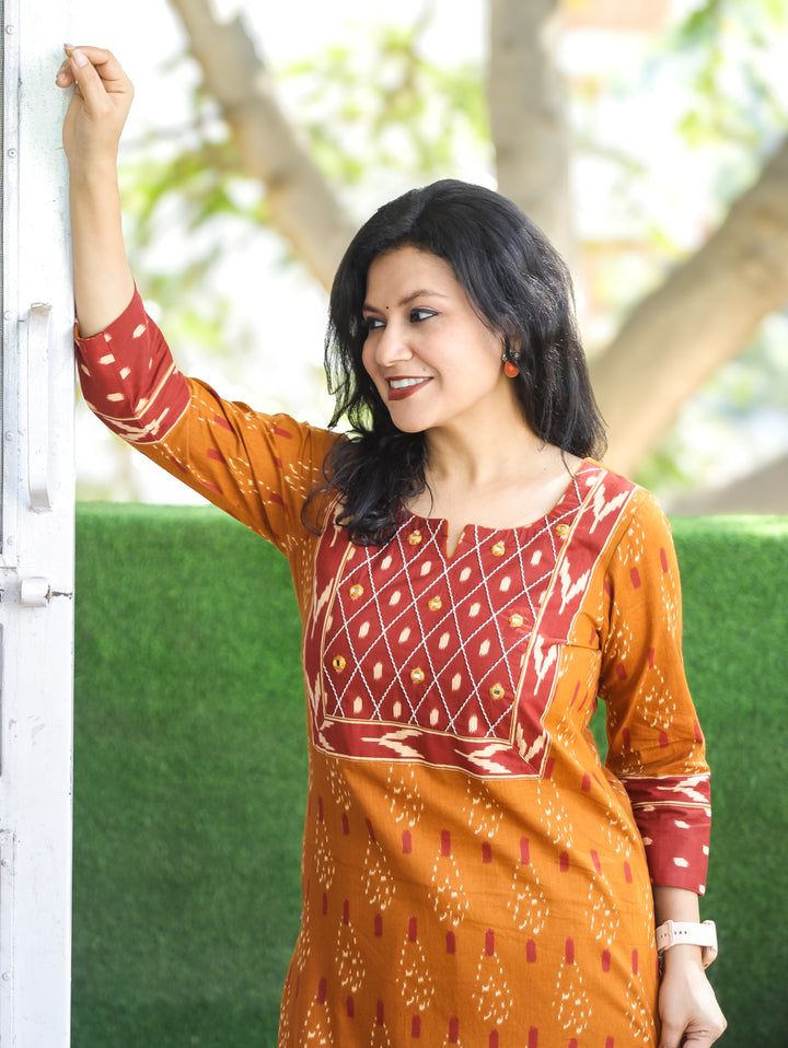 Kesariya Peanut Yellow with Barn Rust Yoke with Mirror Work Ikkat Printed Cotton Kurti