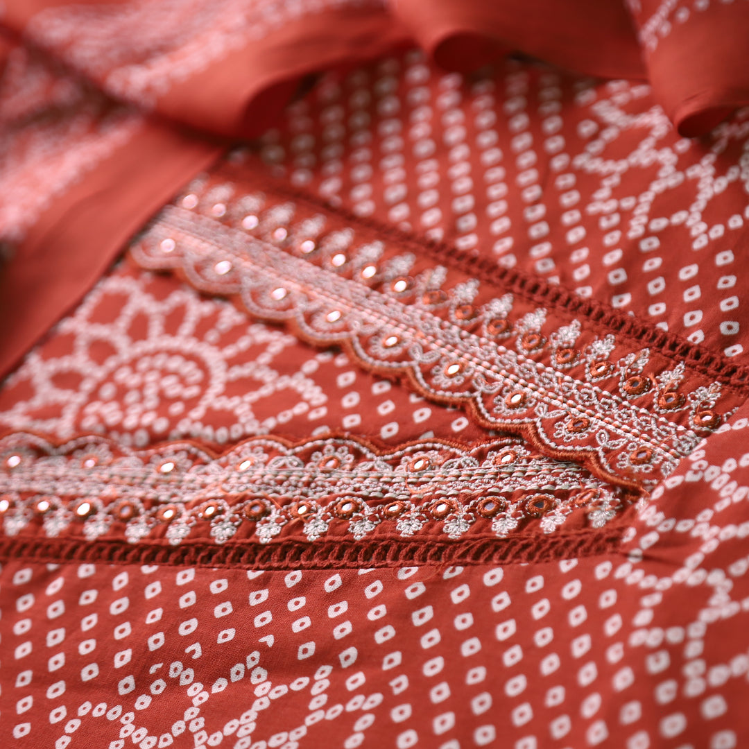 Riwaish Rust Orange Cut Work Thread Lace V Neck Bandhani Print Cotton Suit Set