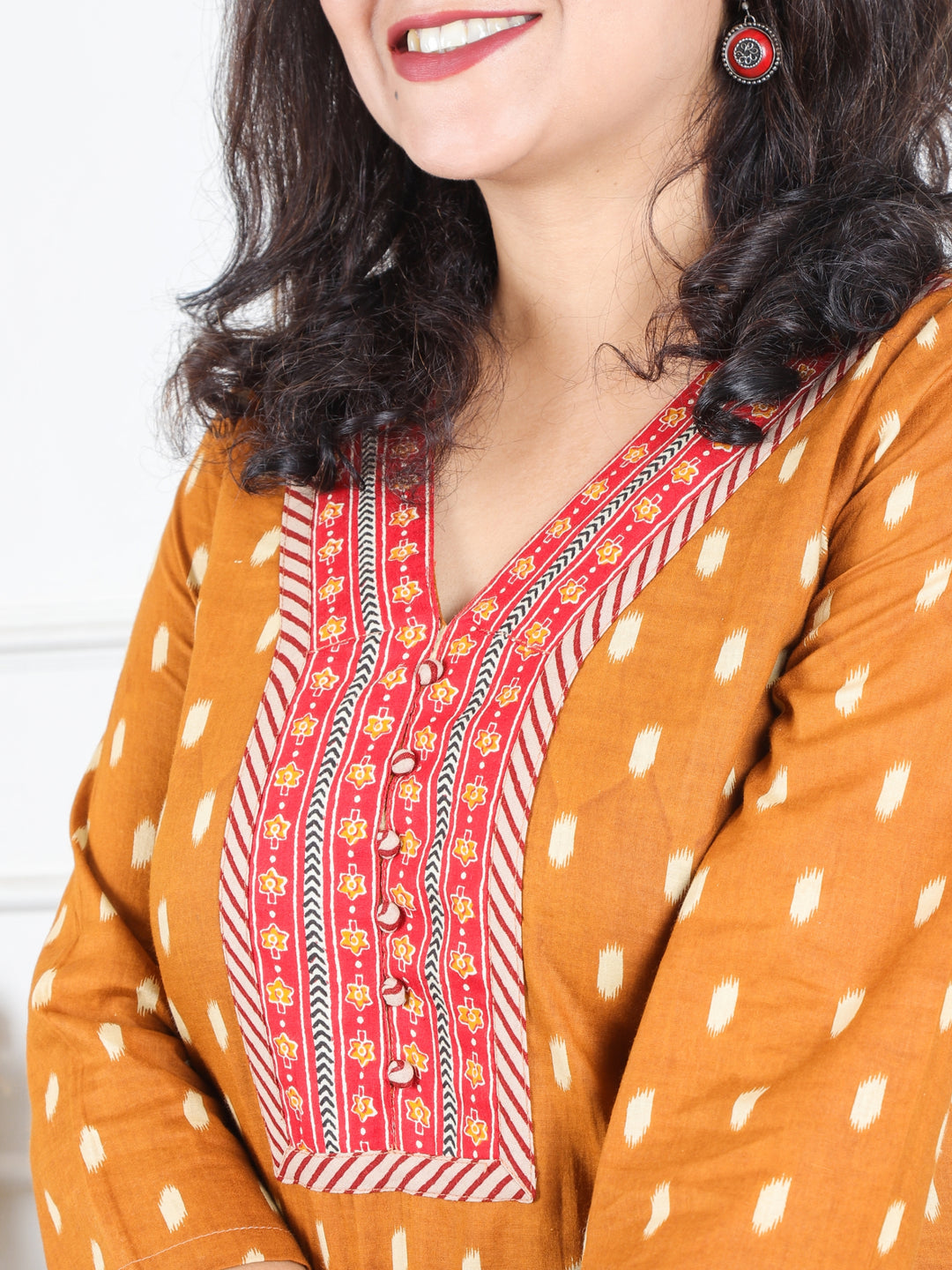 Hariyali Bronze Rust V Neck Lace Work in Ikkat Printed Cotton Kurti